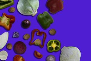 Fresh Various Vegetables, Cabbage, Beets, Peppers, Tomatoes, Onions and Garlic Isolated on Purple Background. Mixed Vegetables Collection, Top View, Flat Lay. Vegetable Mix. photo