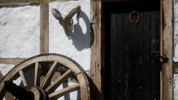 gammalt trähjul och svart dörr på vita huset video