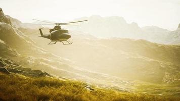 slow motion Vietnam War era helicopter in mountains video