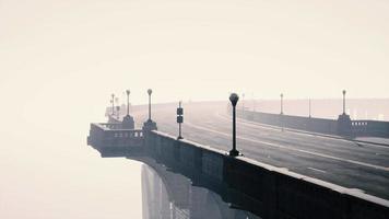 ponte stradale vuoto illuminato in una nebbia