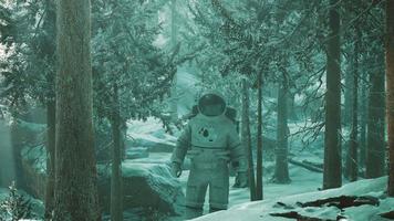 Astronaut exploring forest in snow video