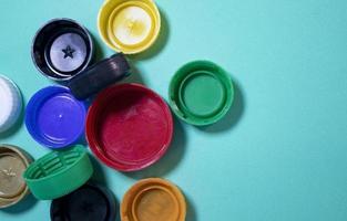 Close-up of multi-colored plastic lids. Plastic Lids on a Blue Background. Bottle Caps, Plastic Recycling.