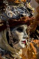 Venice, Italy - February 10, 2013 - Unidentified person with traditional Venetian carnival mask in Venice, Italy. At 2013 it is held from January 26th to February 12th. photo