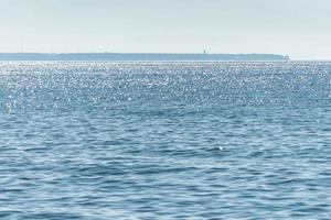 Sunny seascape, Part of the peninsula in the distance, Calm and good weather, No wind photo