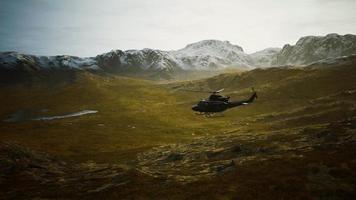 slow motion Vietnam War era helicopter in mountains video