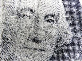 Closeup George Washington on one dollar bills. photo