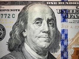 Benjamin Franklin face on us one hundred dollar bill macro. United states money. photo