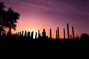 Silhouette Buddha Statue in Wat Mahathat Temple in Sukhothai Historical Park, Sukhothai Province, Thailand . photo