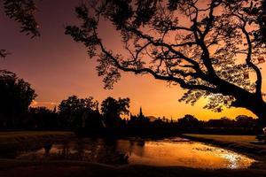 Silhouette Buddha Statue in Wat Mahathat Temple in Sukhothai Historical Park, Sukhothai Province, Thailand . photo