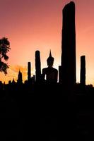 silueta estatua de buda en el templo wat mahathat en el parque histórico de sukhothai, provincia de sukhothai, tailandia. foto