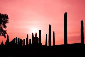 Silhouette Buddha Statue in Wat Mahathat Temple in Sukhothai Historical Park, Sukhothai Province, Thailand . photo