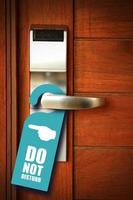 Do not disturb sign hang on door knob photo