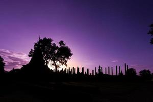 Silhouette Buddha Statue in Wat Mahathat Temple in Sukhothai Historical Park, Sukhothai Province, Thailand . photo