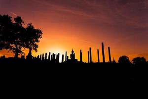 Silhouette Buddha Statue in Wat Mahathat Temple in Sukhothai Historical Park, Sukhothai Province, Thailand . photo