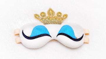 Princess sleep mask on a furry white background with crown photo
