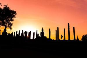 silueta estatua de buda en el templo wat mahathat en el parque histórico de sukhothai, provincia de sukhothai, tailandia. foto