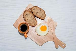 fried egg bread slice in cutting board have espresso coffee photo