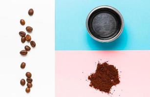 Espresso machine filter, ground coffee and coffee beans on blue, white and pink  background. photo