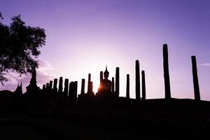 Silhouette Buddha Statue in Wat Mahathat Temple in Sukhothai Historical Park, Sukhothai Province, Thailand . photo