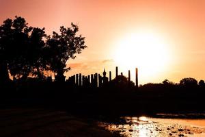 Silhouette Buddha Statue in Wat Mahathat Temple in Sukhothai Historical Park, Sukhothai Province, Thailand . photo