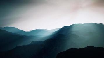 black rocky mountain silhouette in deep fog video