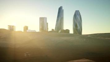 city skyscrapes in desert at sunset video