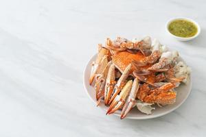 Steamed blue crab with spicy seafood sauce photo