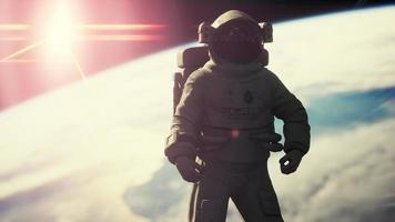 Space man astronaut in space on a background of the blue planet Earth video