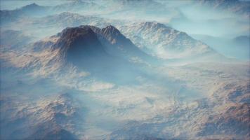 Distant mountain range and thin layer of fog on the valleys video