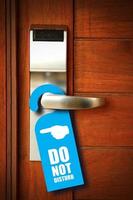 Do not disturb sign hang on door knob photo