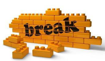 break word on yellow brick wall photo
