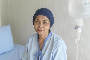 Portrait of senior cancer patient woman wearing head scarf in hospital, healthcare and medical concept photo