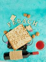 Pesach celebration concept - jewish Passover holiday. Matzah on stand made of marble with walnuts and wildflowers. photo