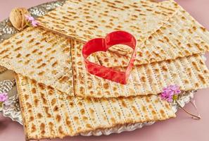 Pesah celebration concept - jewish Passover holiday. Matzah and heart-shaped item photo