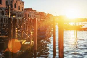 Gondolas in Venice - sunset with San Giorgio Maggiore church. Venice, Italy photo