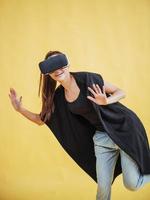 Happy woman gets experience of using VR-glasses virtual reality headset photo