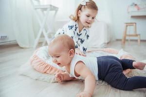 Two sisters playing in a beautiful bright room photo