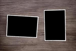two blackened old vintage photo templates on wooden background
