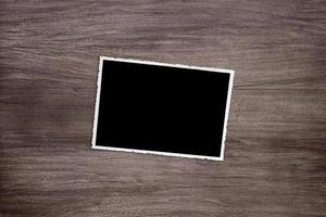 blacked out old vintage photo template on wooden background