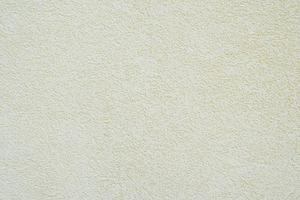 off-white or pale yellow roughcast plaster texture background wall photo