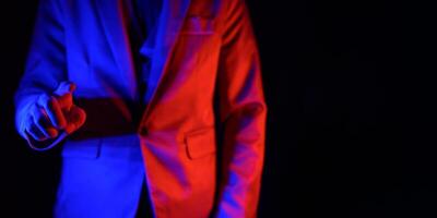 A man in a suit with blue and red lights photo
