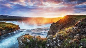 Godafoss waterfall at sunset. Fantastic landscape. Beautiful cumulus clouds. photo