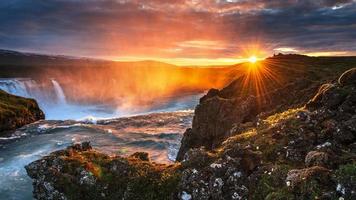 Godafoss waterfall at sunset. Fantastic landscape. Beautiful cumulus clouds. photo