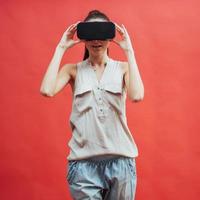 Young attractive Japanese woman using VR-glasses headset photo