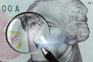 Dollar under a magnifying glass isolated photo