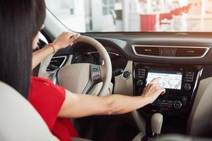 Smart car and internet of things IOT concept. Finger point to car 's console and icons popup out of screen photo