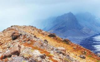 Gentle slopes of snow-capped mountains and glaciers. Wonderful Iceland in the spring. photo