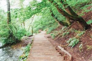 Plitvice Lakes National Park, tourist route on the wooden flooring along the waterfall photo