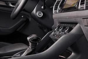 Luxury car Interior - steering wheel, shift lever and dashboard photo