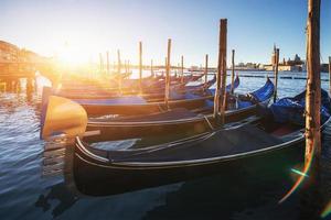 Gondolas in Venice - sunset with San Giorgio Maggiore church. Venice, Italy photo